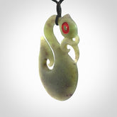 This picture shows a traditional manaia with hook pendant carved in New Zealand Jade.